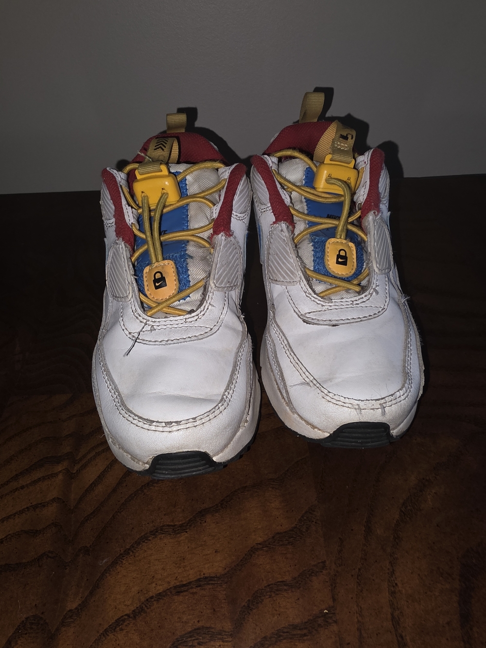 Nike Kids White Sneakers with Red, Blue & Yellow Accents